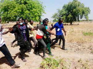 The officer being escorted out of the polling station