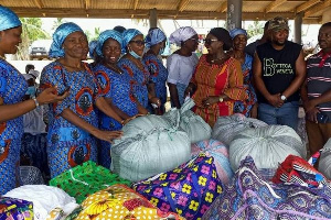 Dzifa Gomashie making a donation to victims of the tidal waves destruction