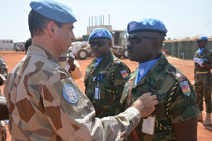 Force Commander decorates the parade Commander, Maj Samuel Yirenkyi