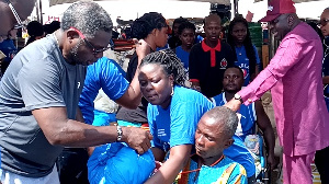 Rev Mathew Ashimolowo handing over items to PWDs