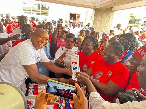 Market women present the form to Ekow Ewusi (left)