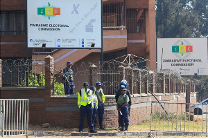 Police guard the offices of the Zimbabwe Election Commission as vote counting continues