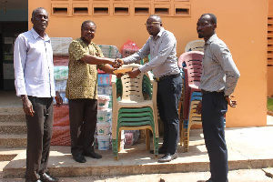 Yaw Asante receiving the items on behalf of the Assembly during the presentation