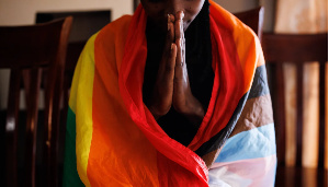 A member of the LGBTQ community prays during an evangelical church service