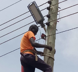 Mugis Nbegamsi installing streetlights in his electoral area