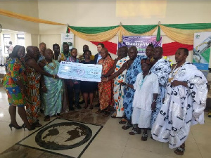 Officials of SSGL handing over the cheque to some elders of James Town