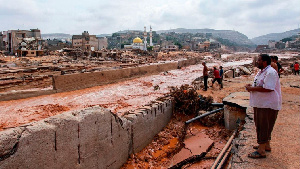 People looking at the damage caused by freak floods in Derna, eastern Libya, on September 11, 2023