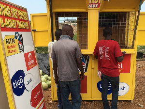 A Mobile Money agent serving clients