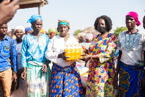 Professor Naana Opoku-Agyemang donating to old women