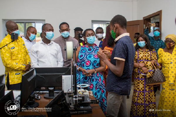 Ursula Owusu-Ekuful interacting with a student during the unveiling of ICT library and robotics lab