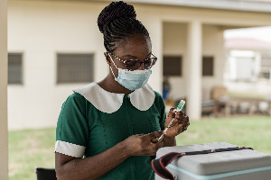 A nurse is seen here about to administer a jab of the vaccine