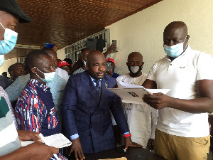 Mr Okyere Baafi presentidng his nomination forms  at the EC office