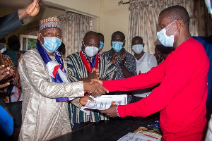 Alhaji Boniface handing over his forms to Mr. Livingston Amoako, the Returni Officer(R.O) of Madina