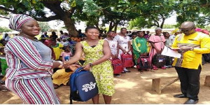 Miss Salpawuni Muniru presenting the scholarship bags to the girls