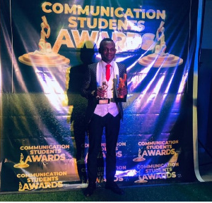 Stephen Bernard Donkor holding his trophies