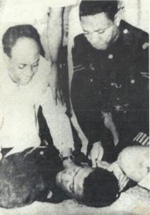 Kwame Nkrumah is photographed here crouching over Constable Ametewee