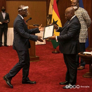 Prez Akufo-Addo presenting charter certificate to  Apostle Dr. Daniel Walker(Rector Pentecost Uni)