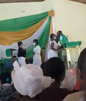 Rev. Obeng Larbi kissing a student at the St Monica's College of Education