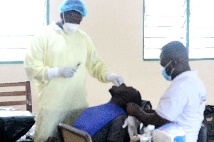 Health workers attend to a resident of Nhyiaeso