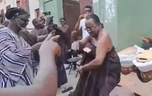 Dr Owusu Afriyie Akoto (in black cloth) daning at a funeral