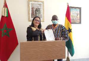 Madam Imane Ouaadil (left) presenting the citation to Mr Stephen Mahamudu Yakubu