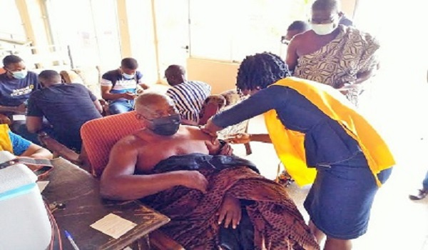 A Chief receiving his jab of the coronavirus vaccine