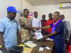 Nana Akomea Jnr (right) submitting his nomination forms to constituency executives