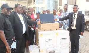 Management of the GCB bank presenting the items to staff of the university