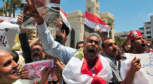 Protesters shout slogans and hold portraits of Egypt's President Abdel Fattah al-Sisi