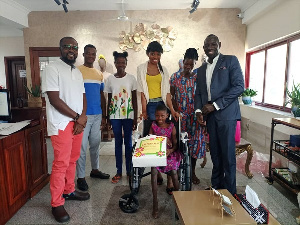 A wheelchair, some clothing, and exercise books were presenetd to Agnes Mba by KOD