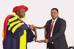 Reverend Christian Kweitsu receiving his citation from Dr Richard Eghan, a COGAI Executive