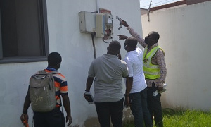 Officials from ECG checking meters at East Legon