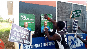 Irate NPP members fixing Mahama's posters at party office