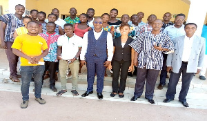 The DCE, Daniel Kwame Gariba with some of the beneficiaries in a group picture