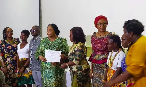 Rebecca Akufo-Addo receiving a citation from the Childhood Cancer Society of Ghana